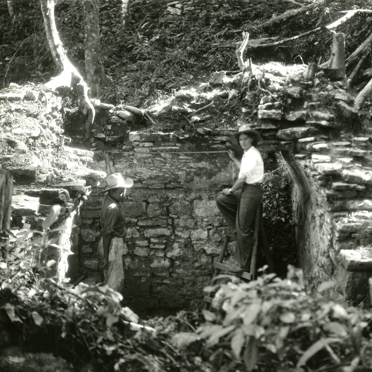 a man and woman standing at piedras negras, guatemala in 1936 black and white photo