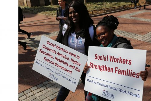 Women holding signs for Social Workers