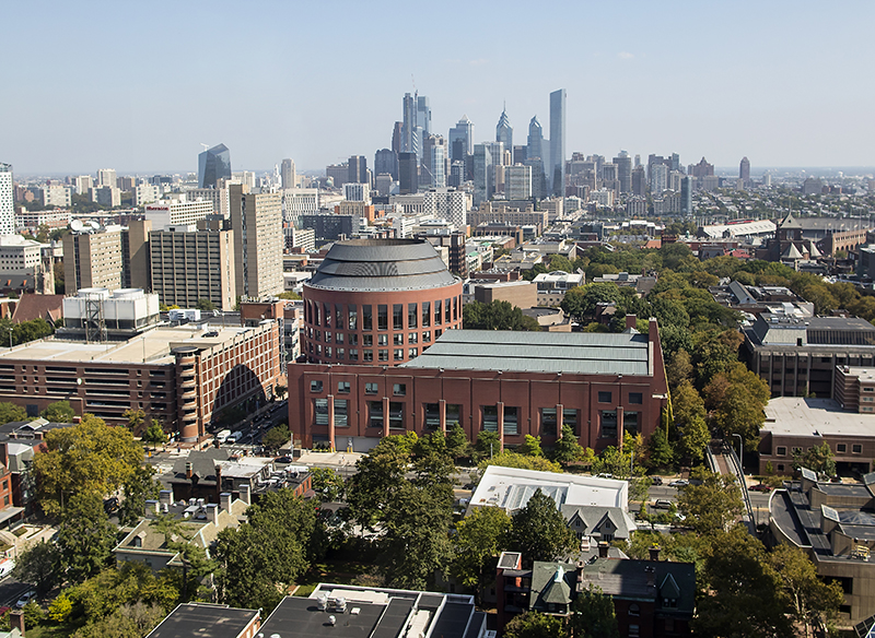 An image depicting Huntsman Hall in the foreground with the Philadelphia skyline in the background.