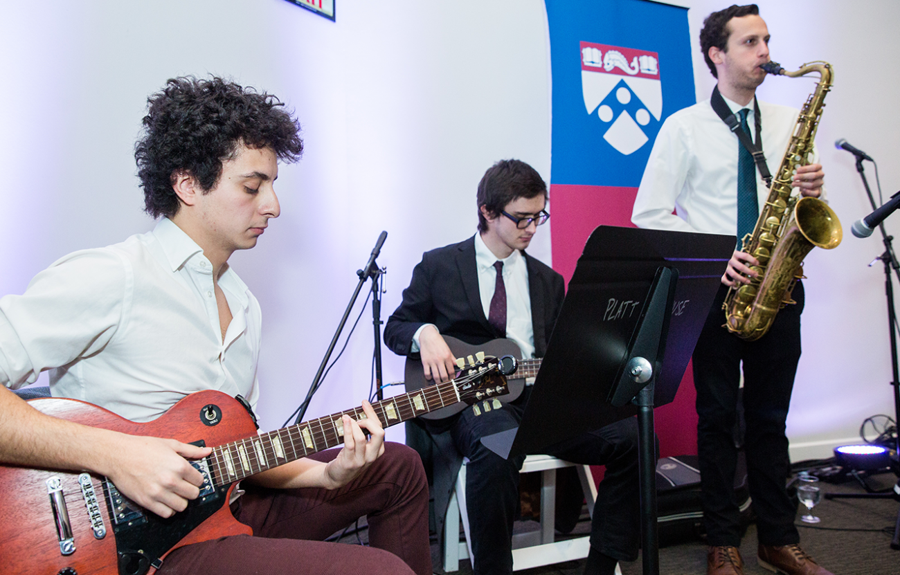 three people playing instruments at an event