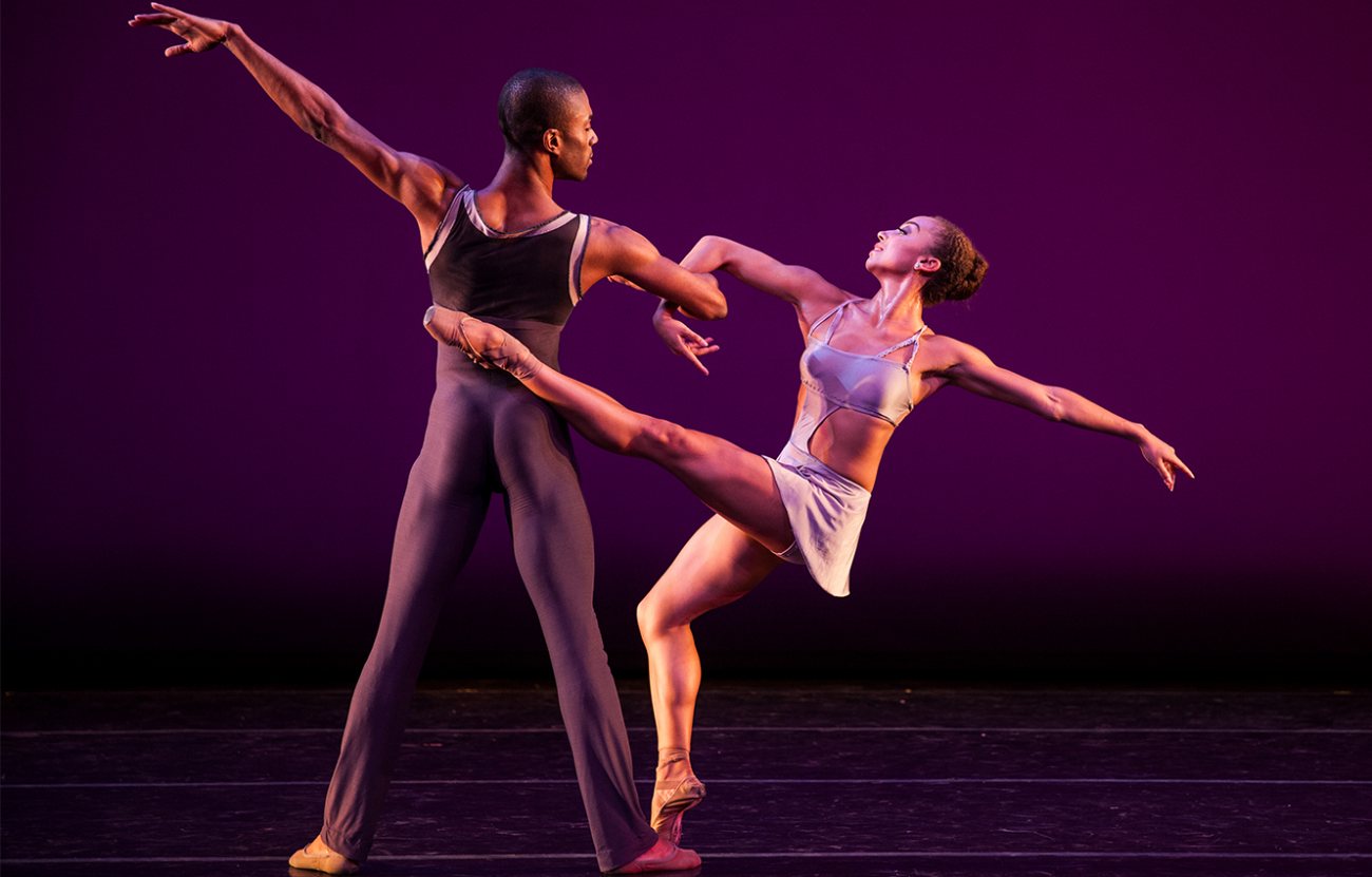 two ballet dancers on stage performing