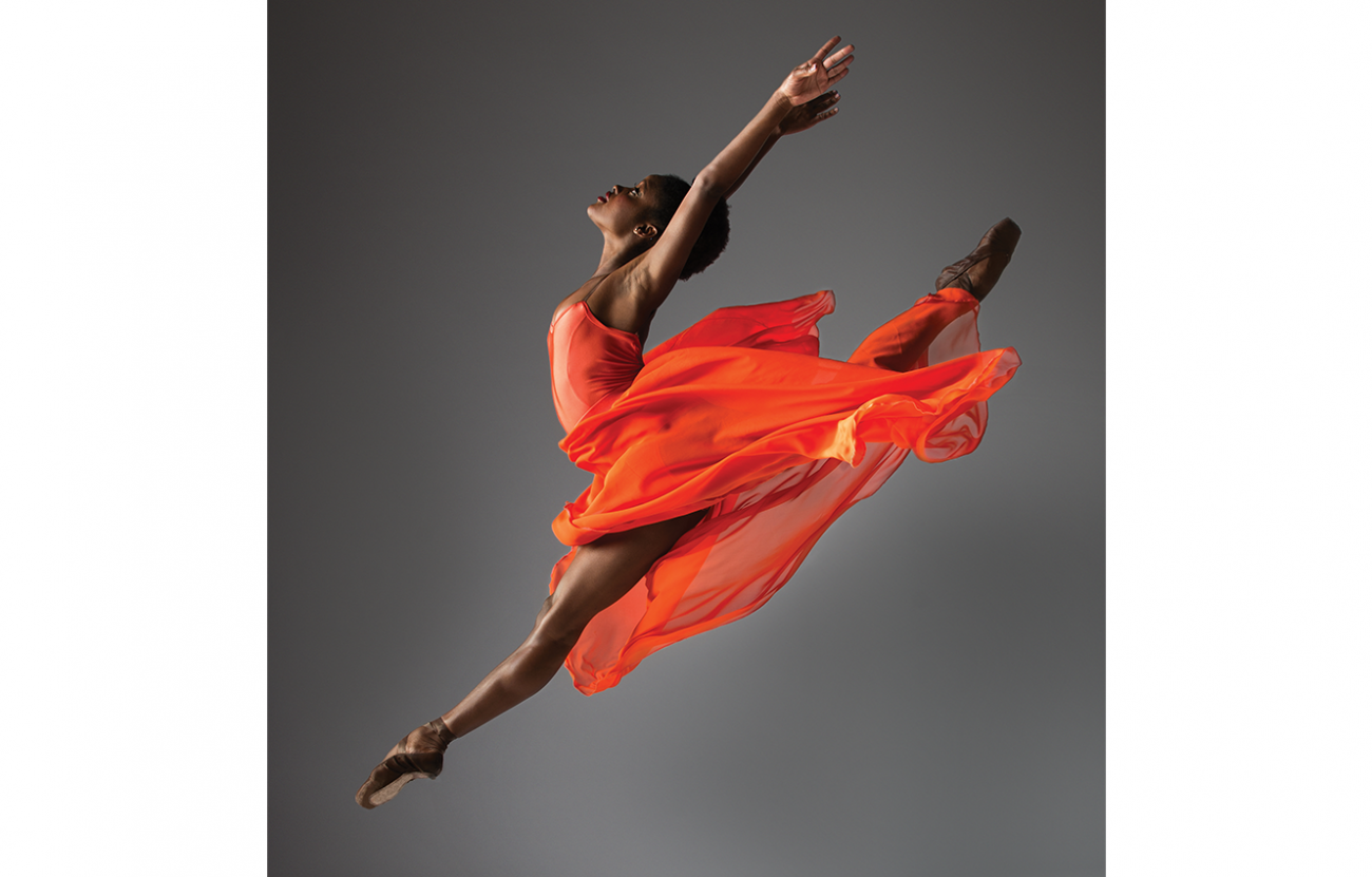 ballet dancer in mid air doing a split