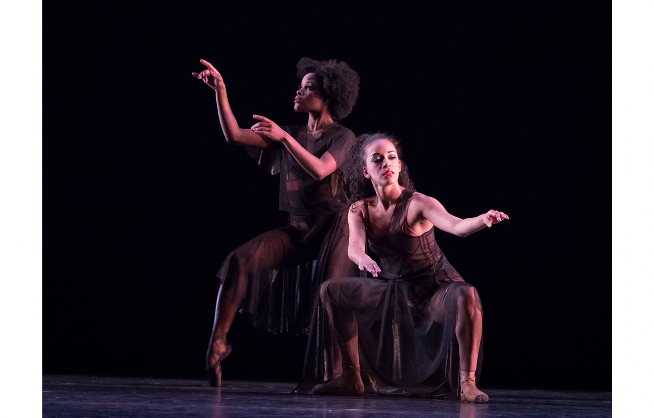 two ballet dancers on stage in performance