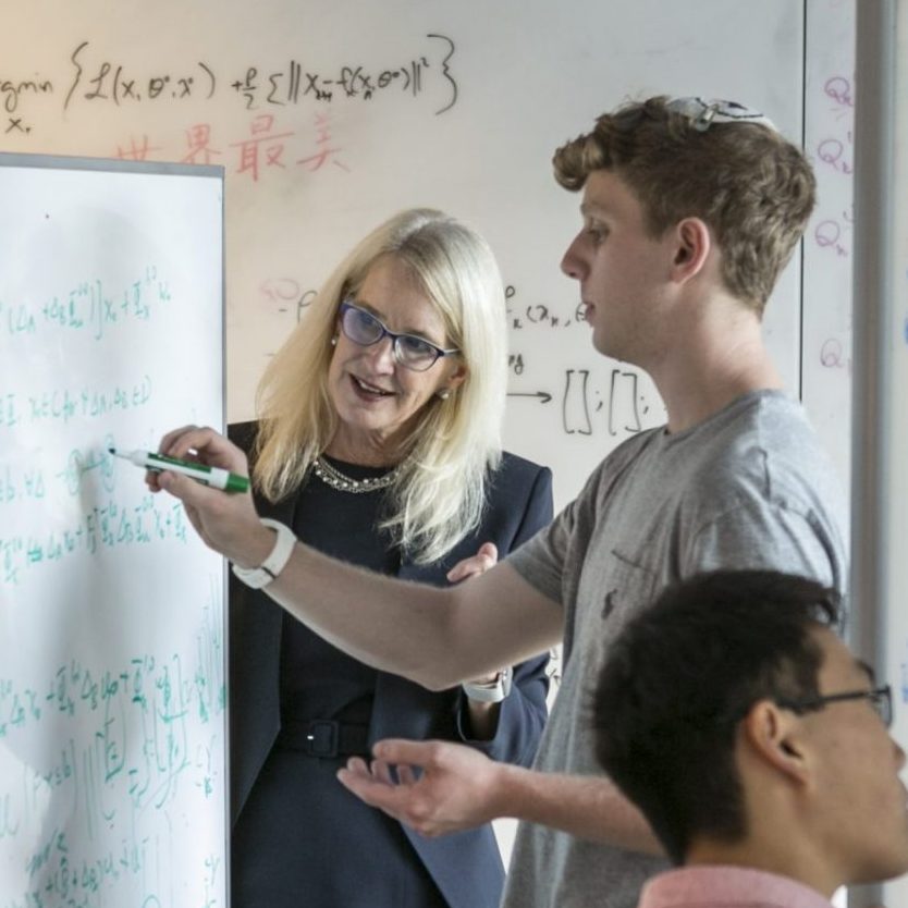 professor helping student write equations