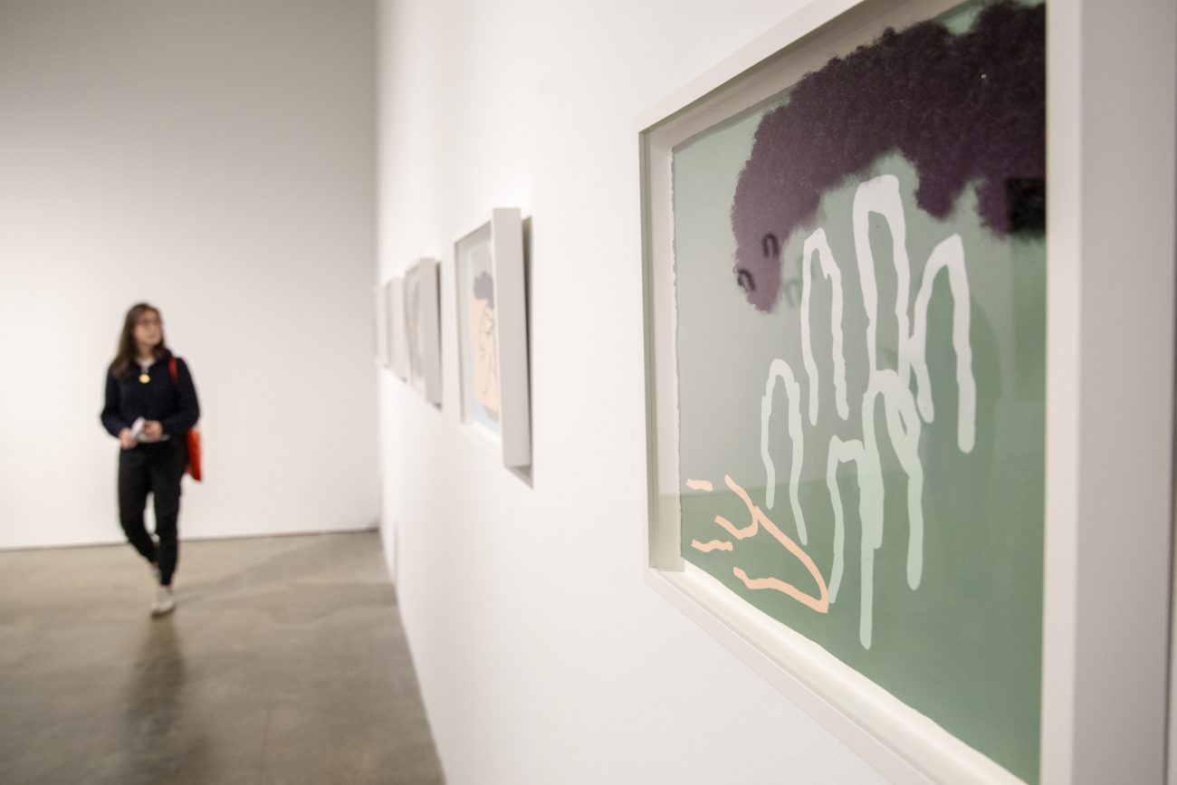 framed art hanging on the wall of a museum