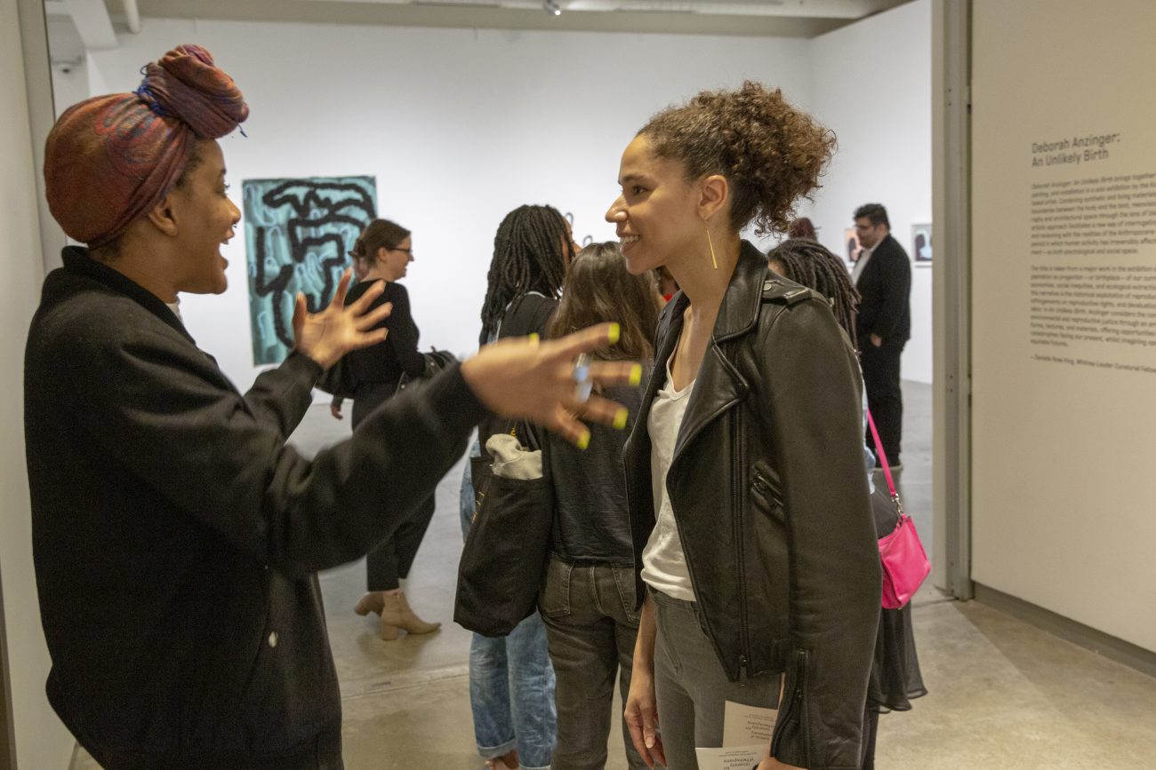 two people talking at a museum