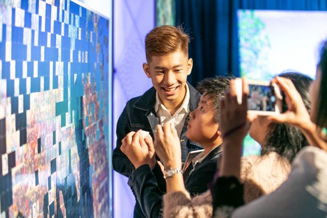 Campaign supporters contribute to a photo mosaic at the Hong Kong tour event.