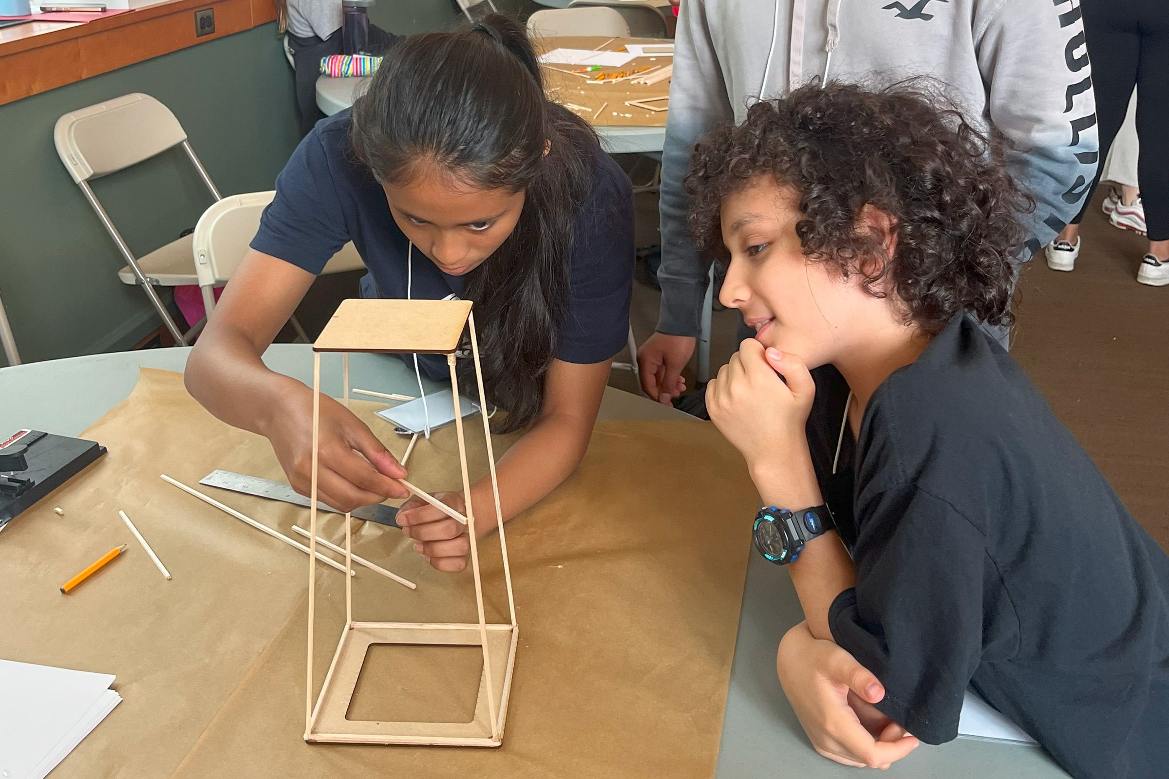 Two GEMS campers work together to build a tower