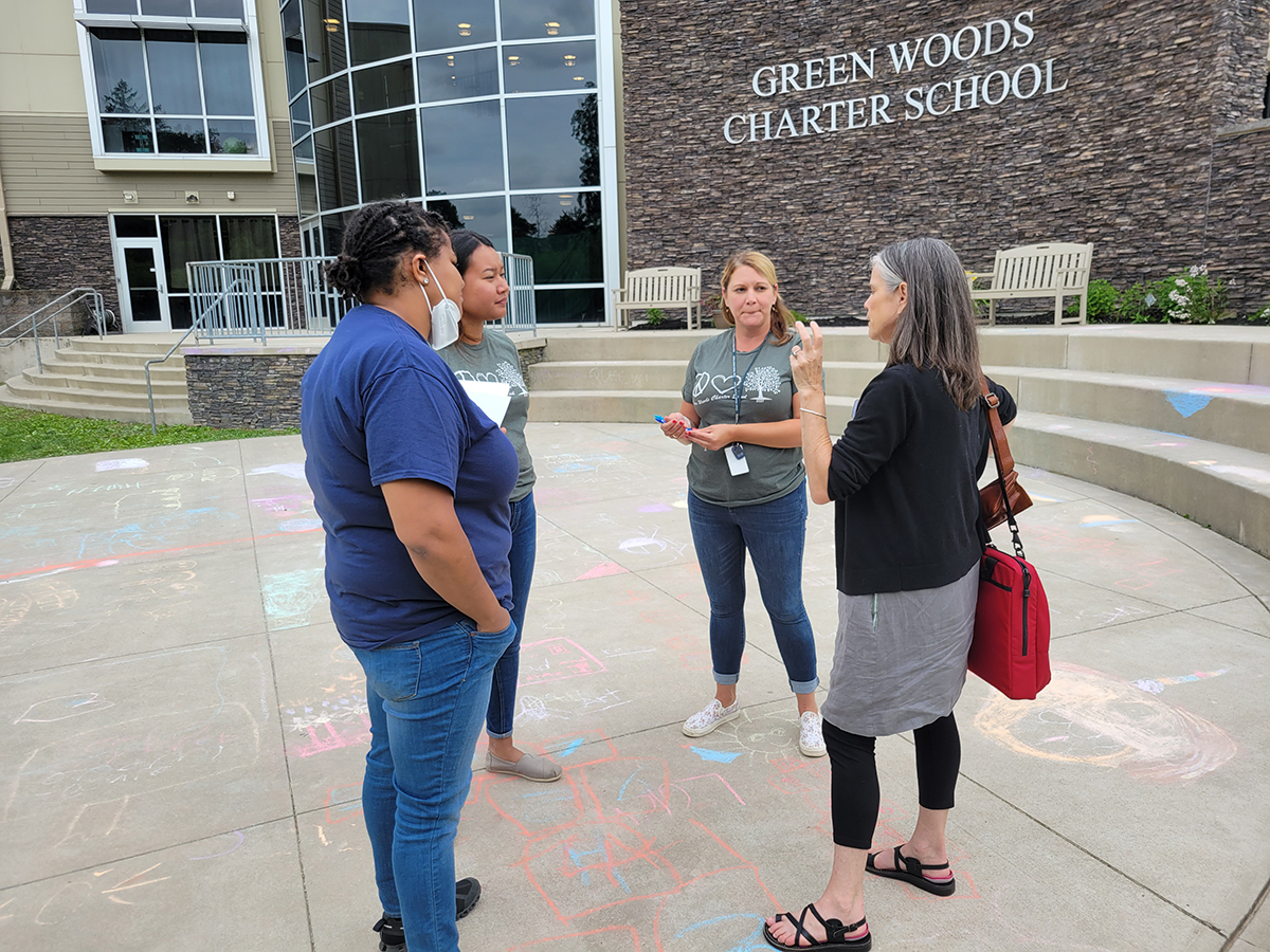 Four individuals talking in group