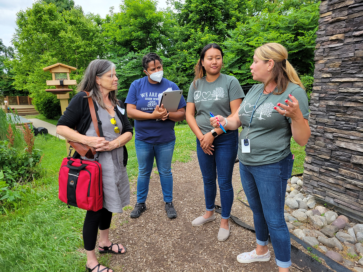 Four individuals talking in group