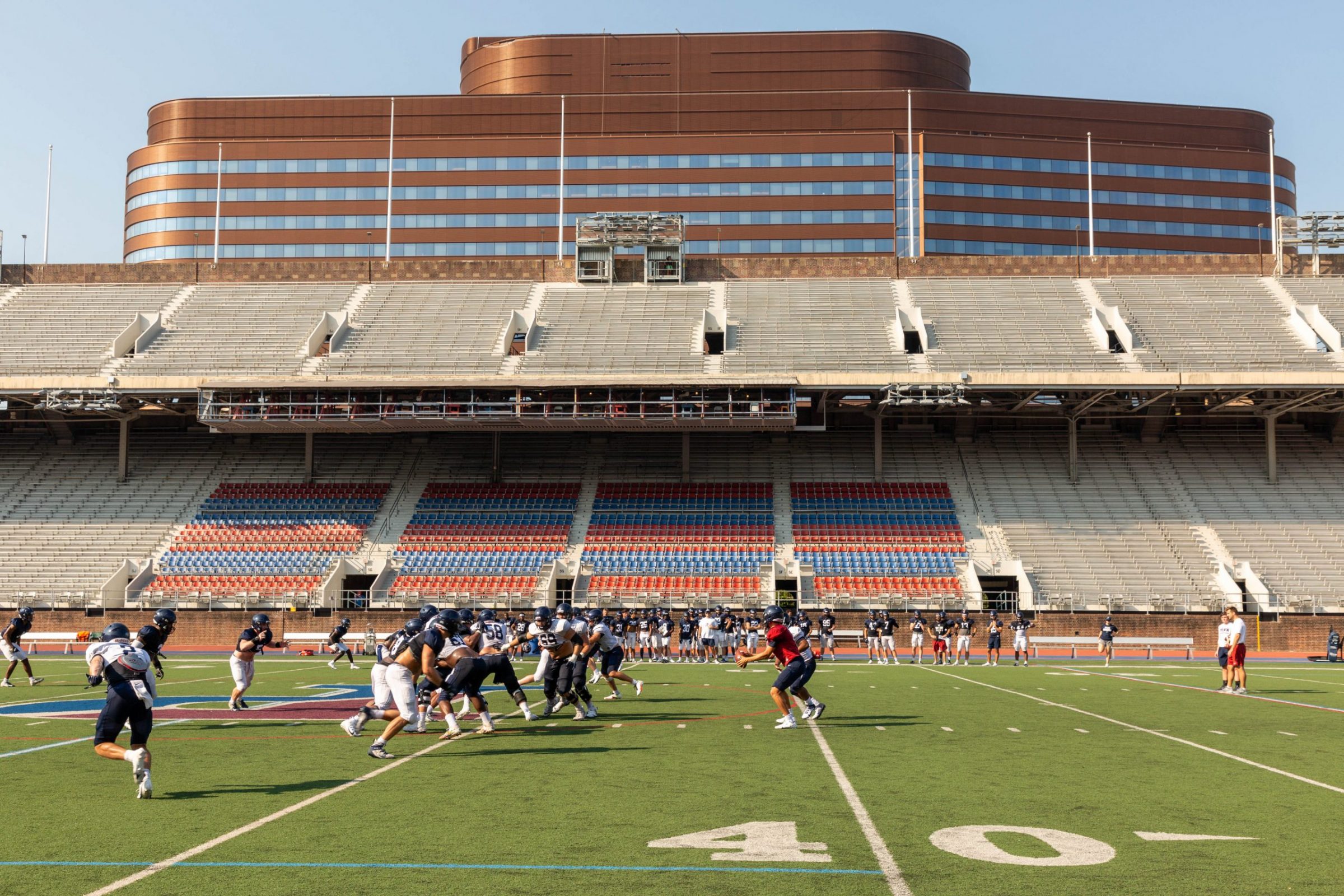Football practice at Franklin Field with the Penn Medicine Pavilion in the background