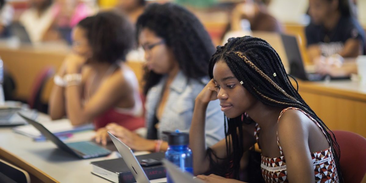 A students looks at her laptop during a class