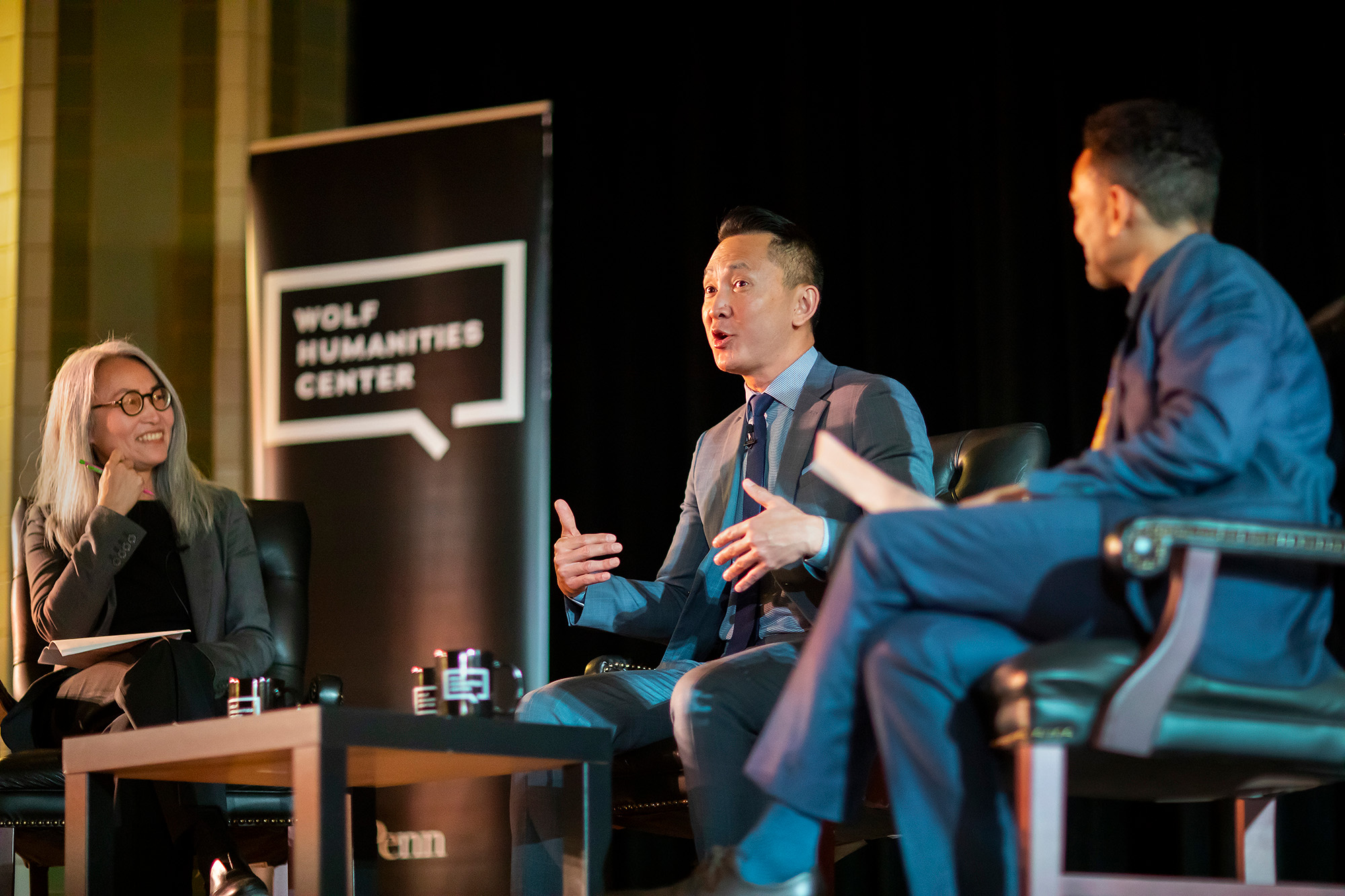 Pulitzer Prize–winning author Viet Thanh Nguyen (center) talks about his work at a Wolf event on the theme of migration.