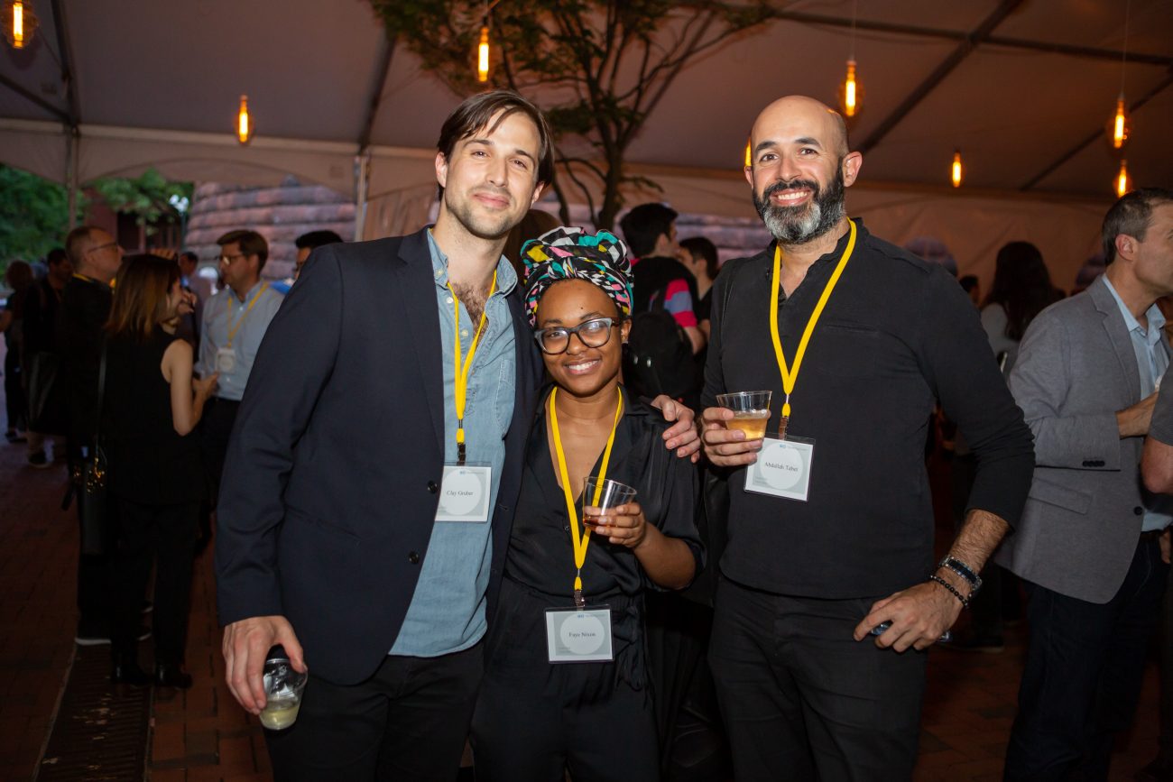 three people at an event posing for a photo