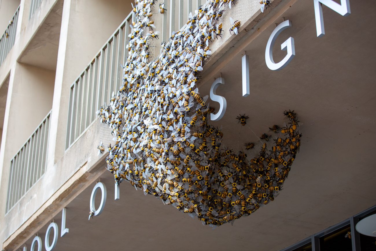 large fake bumble bees swarming a balcony on the school of design building