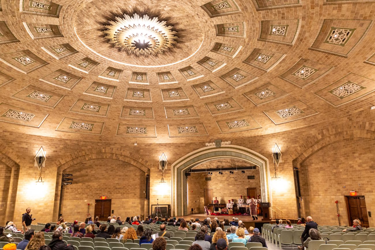 audience watching a performance in the Harrison auditorium