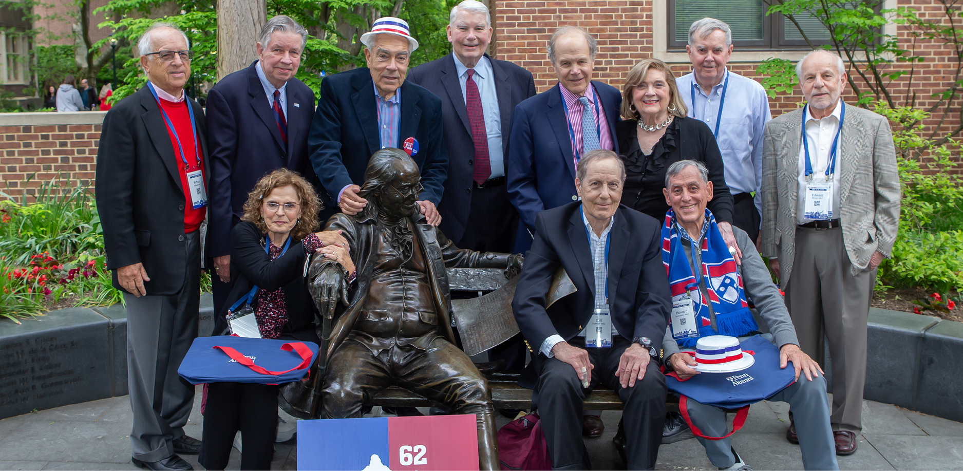 alumni posing with Ben Franklin statue