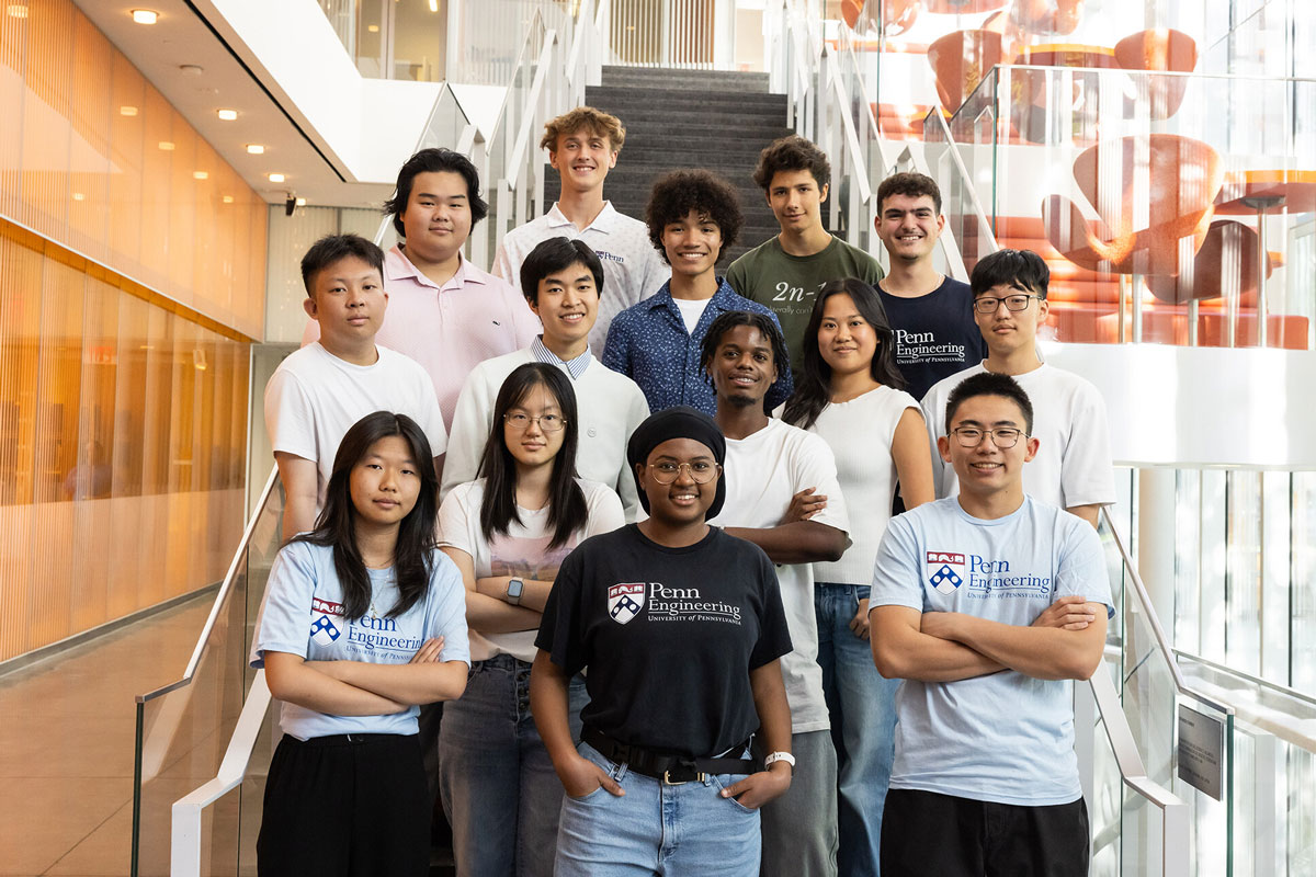 Students from the Clark Scholars Program at Penn Engineering standing in tiers on a staircase for a group portrait.