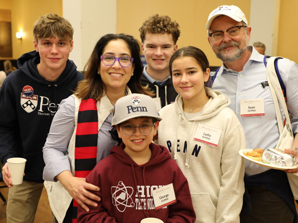 Group photo of smiling faces at a Penn Homecoming Weekend event