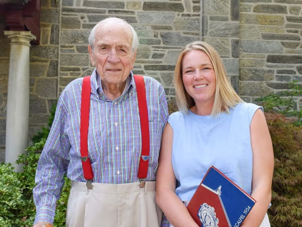 Dean Snyder, V’54, and Jane Annand, V’18, standing together outside on a sunny day.