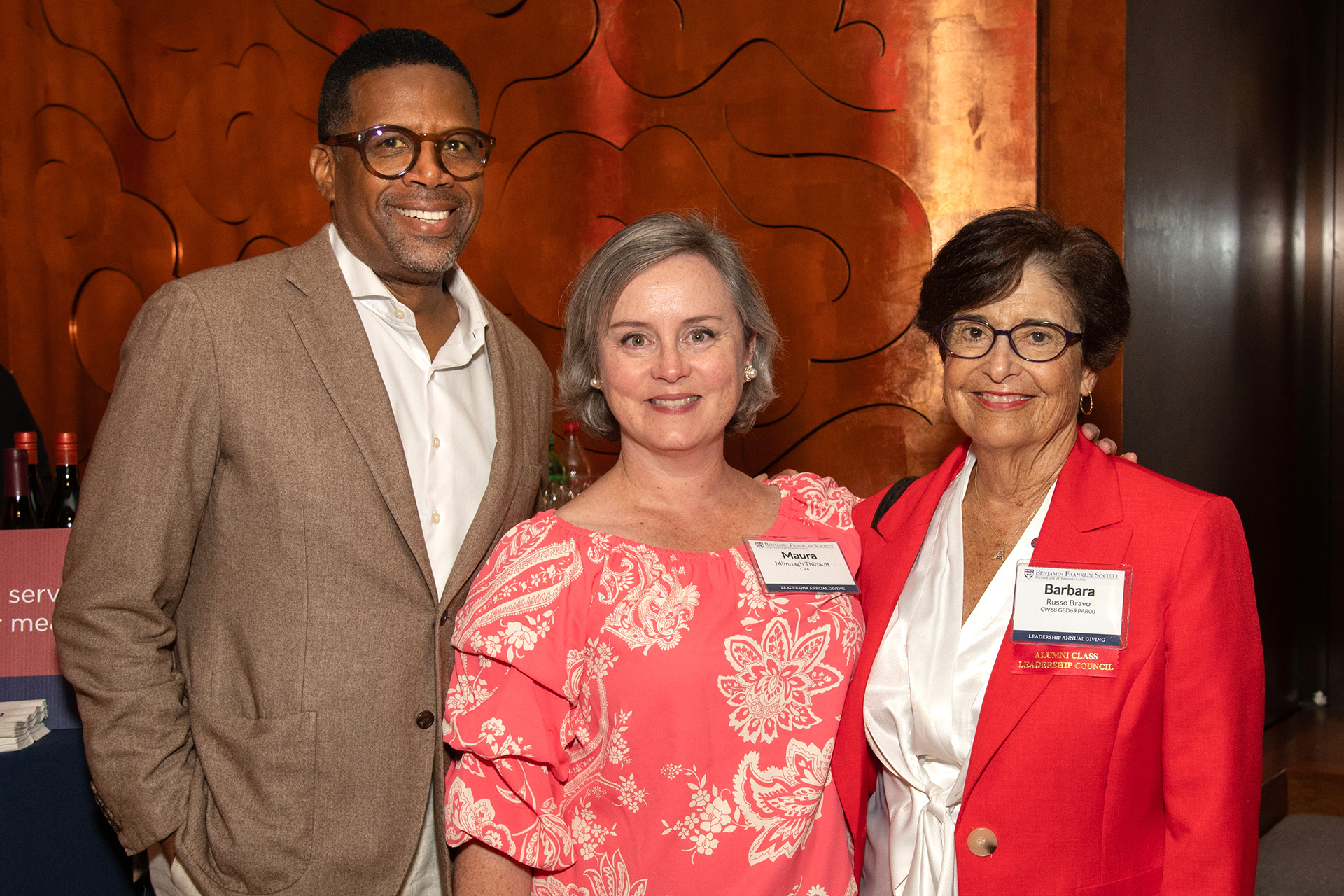 Three Penn alumni pose for a photo at a Benjamin Franklin Society event.