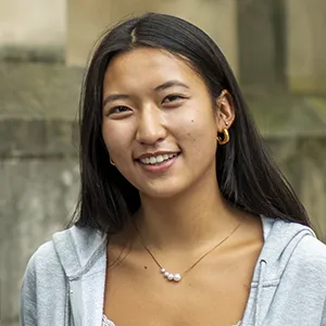 Close-up of Penn student Ashley Tang smiling in front of College Hall.