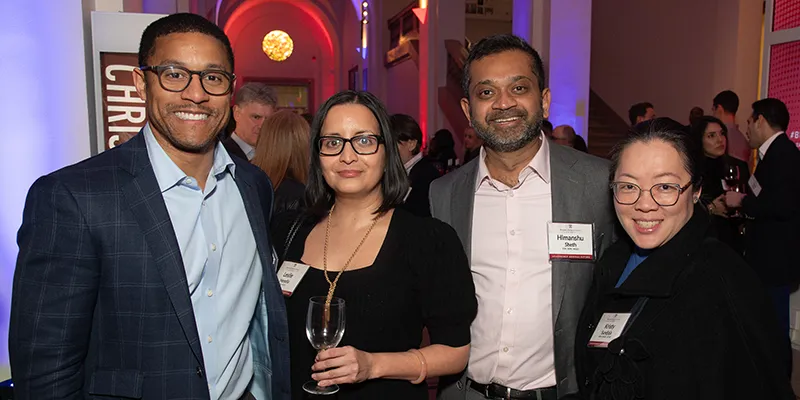 Four attendees gather at the Benjamin Franklin Society NY Reception, enjoying a networking moment at the New-York Historical Society venue.