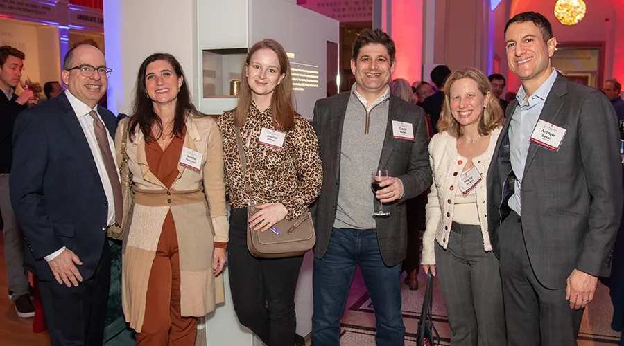 Six attendees at the Benjamin Franklin Society Spring Reception smile for a group photo as they enjoy an evening of networking and celebration.