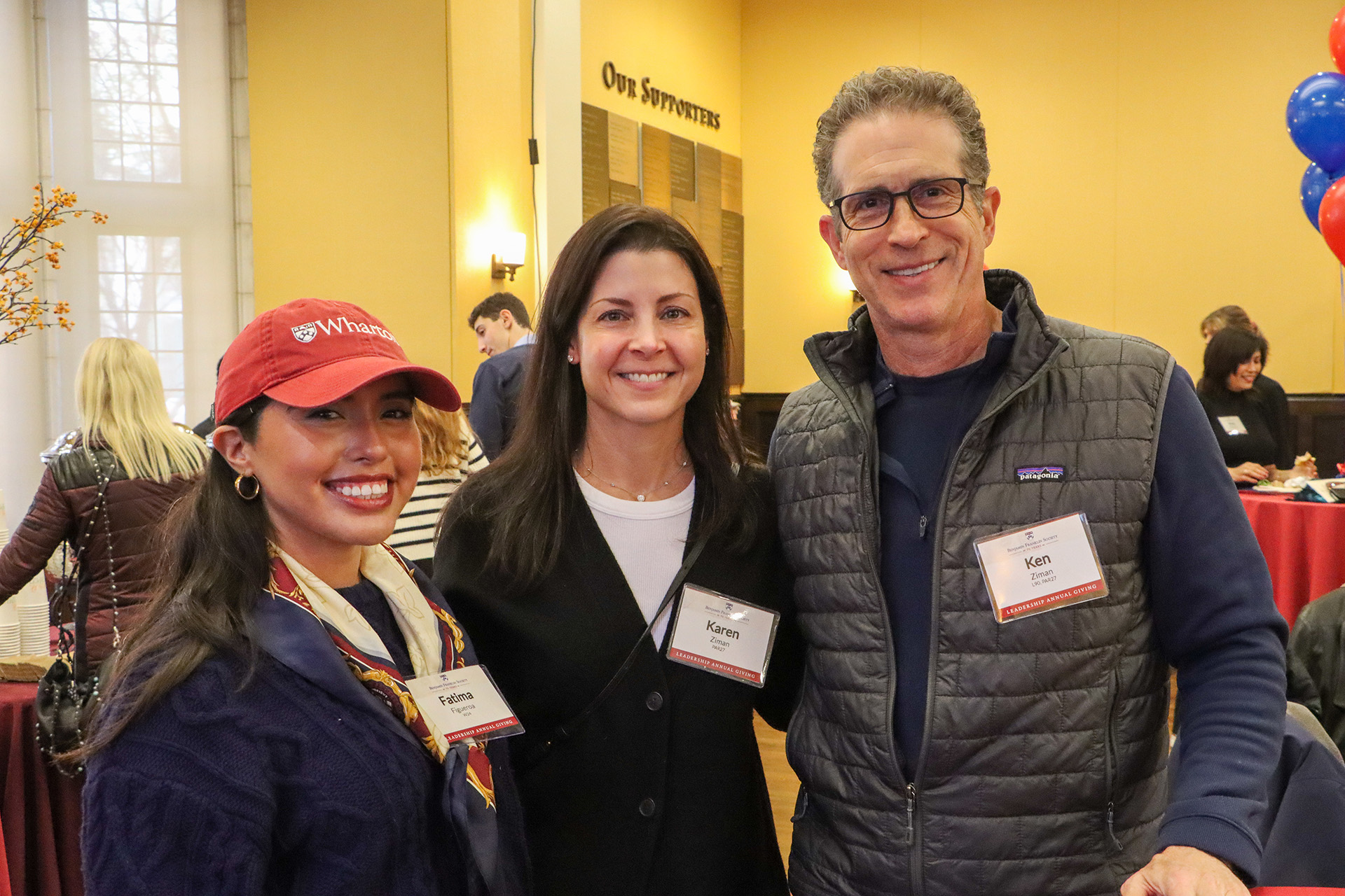 Three Penn alumni pose for a photo at the 2024 Benjamin Franklin Society Brunch.