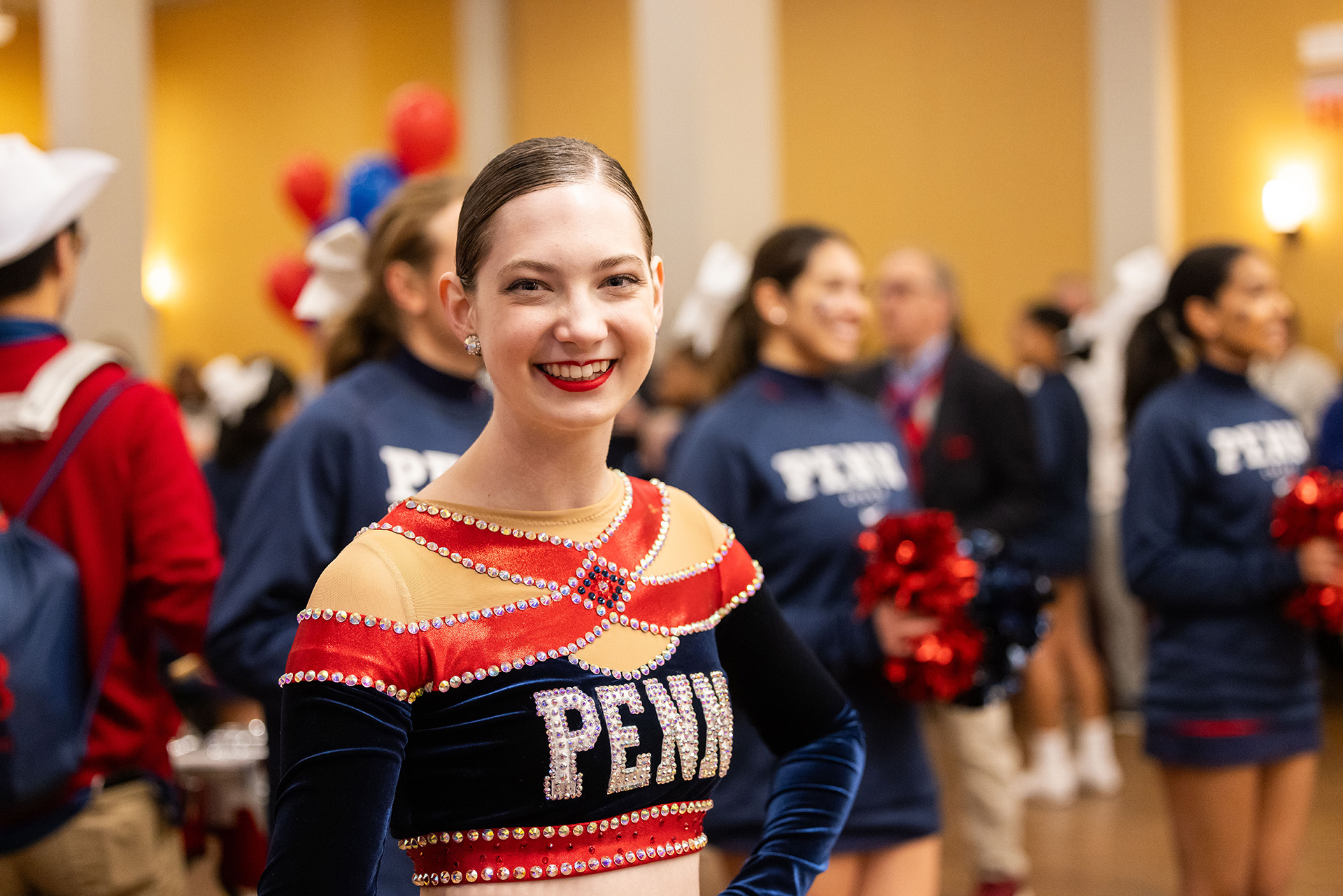 A Penn cheerleader smiles for the camera at the 2024 Benjamin Franklin Society Brunch.