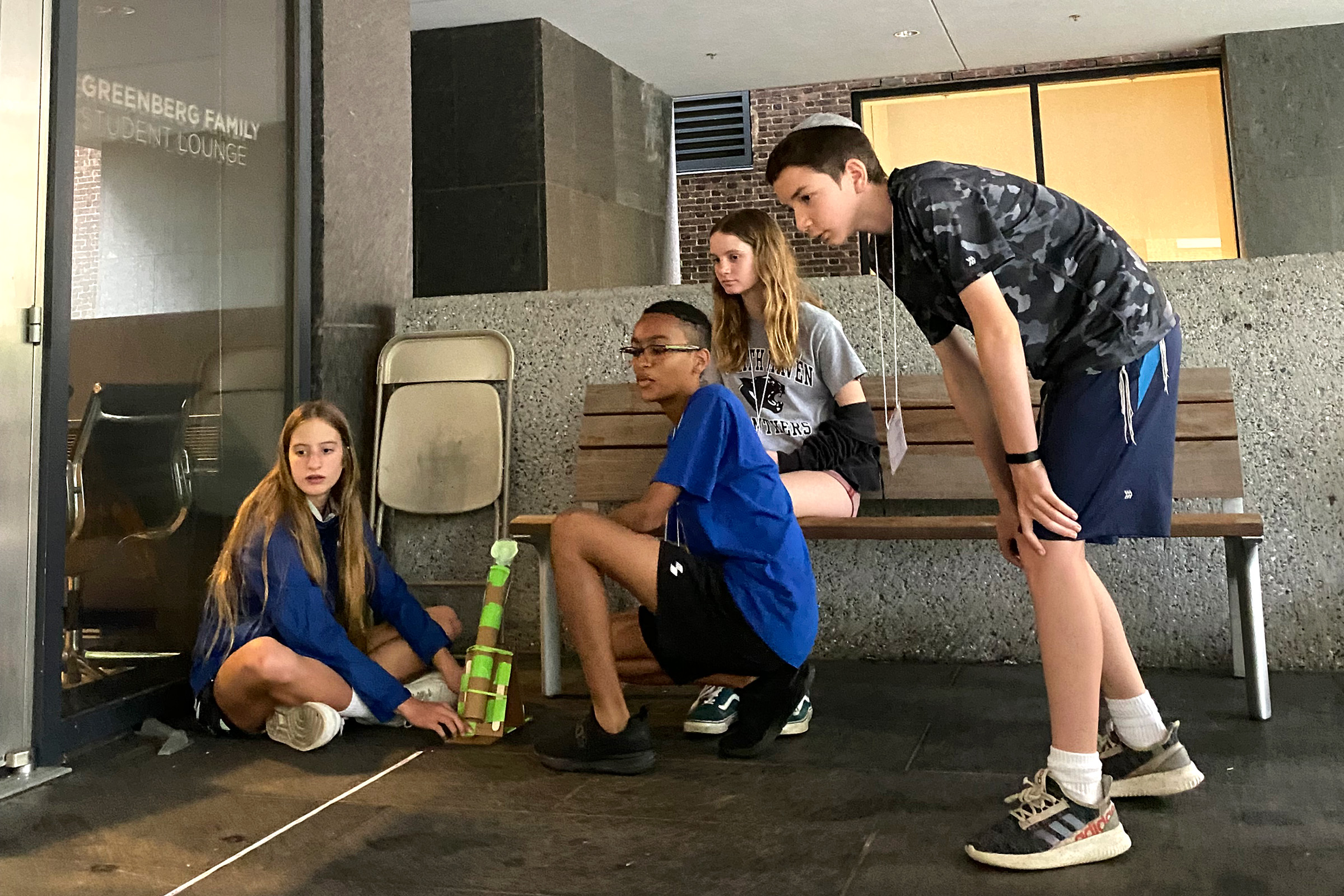 A group of campers tests the range of their newly built miniature catapult