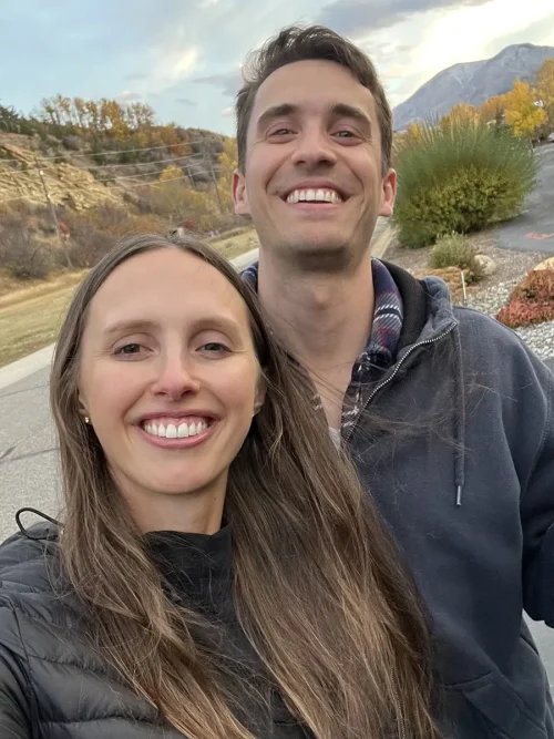 Carly Crist Hutchison and Kent Hutchison smiling together outdoors