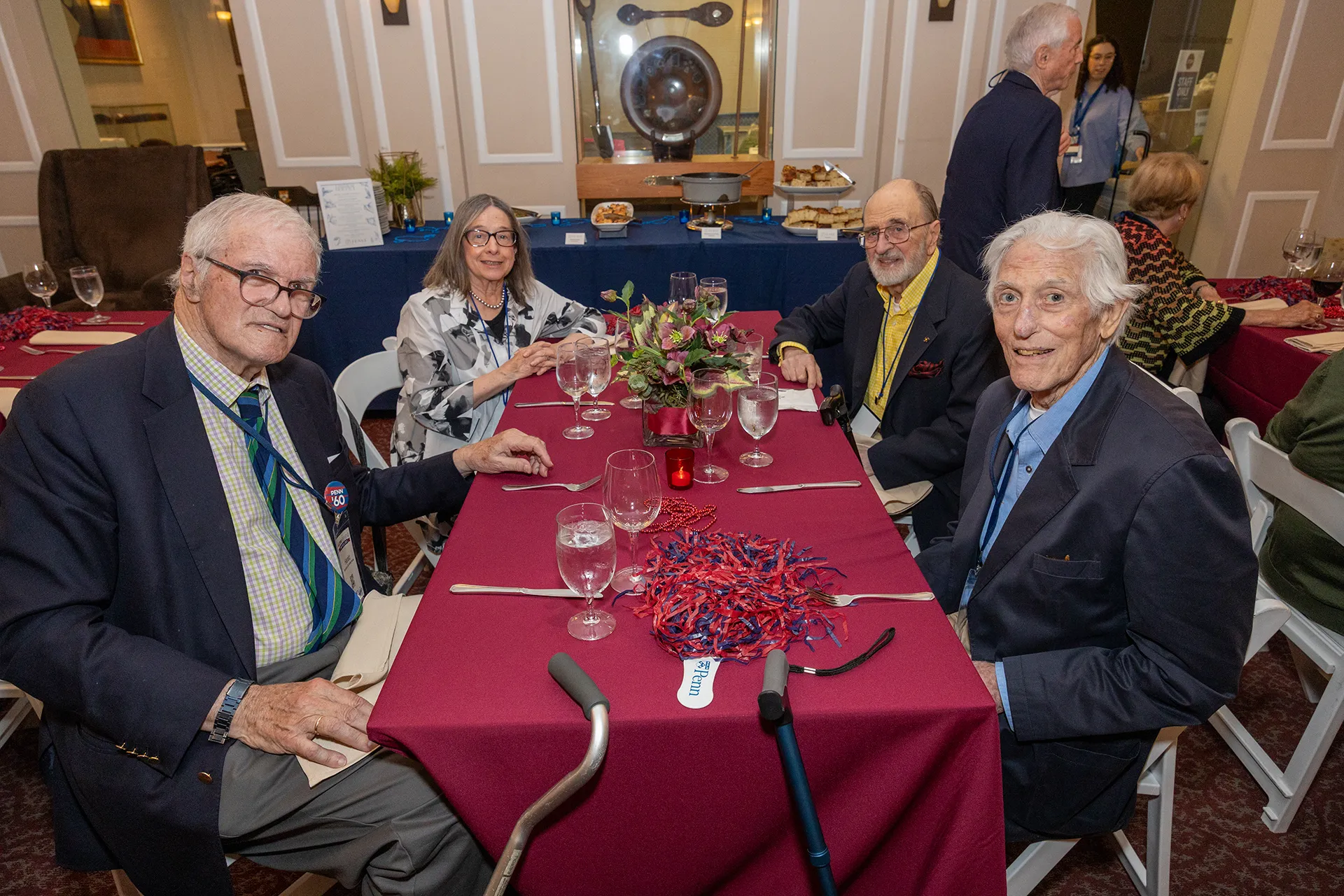 University of Pennsylvania Class of 1960 alumni seated around a burgundy-clothed table at their 65th reunion