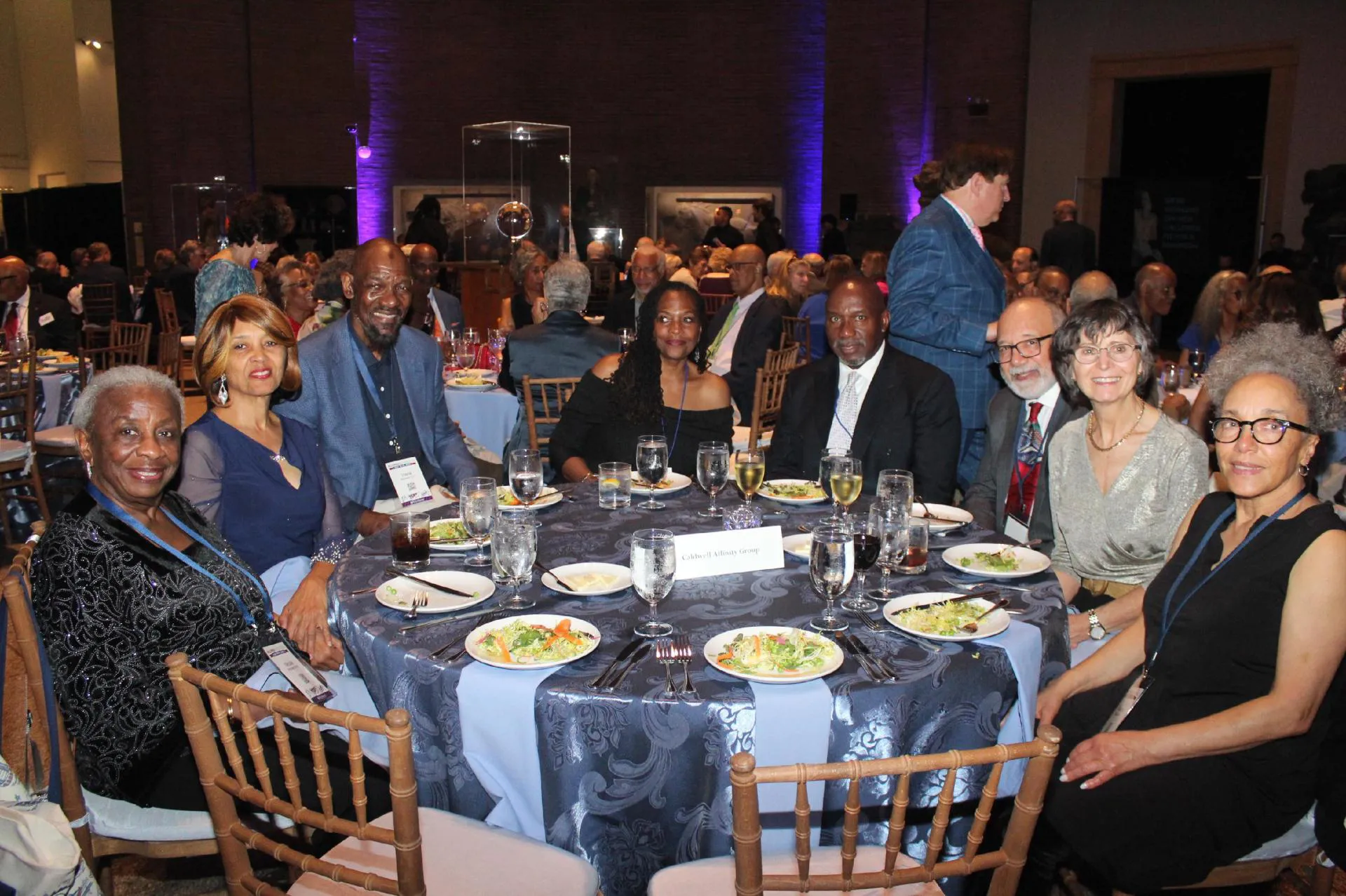 Class of 1975 University of Pennsylvania alumni seated around a banquet table enjoying salad and wine at their 50th reunion gala dinner