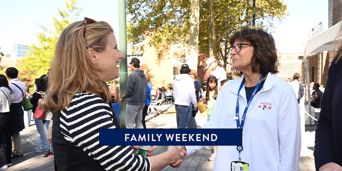 President Magill shakes hands with a Penn community member during Family Weekend 2022.