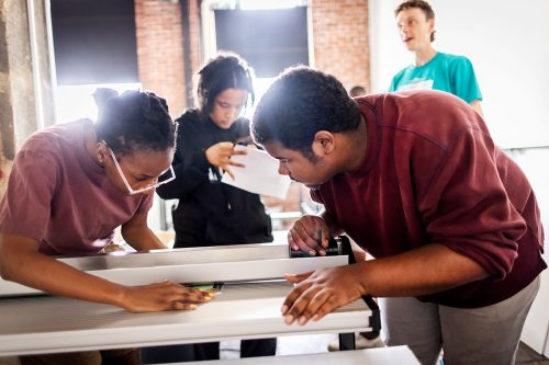 Students from Sayre High School work to construct elements for a photography exhibition created through the Penn Museum's My Food Story program.