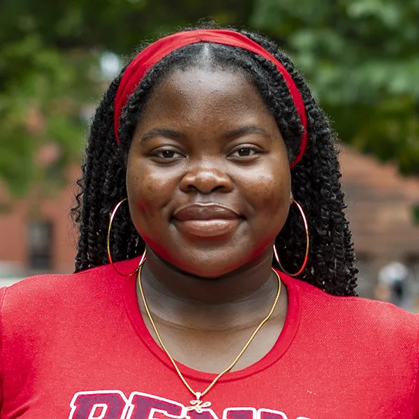Herinah Asaah smiles in an outdoor portrait photo