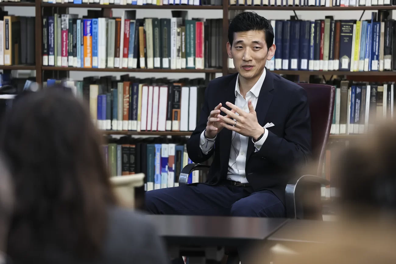 Jisung Park, an environmental and labor economist at the University of Pennsylvania, speaking to an audience in a library setting.