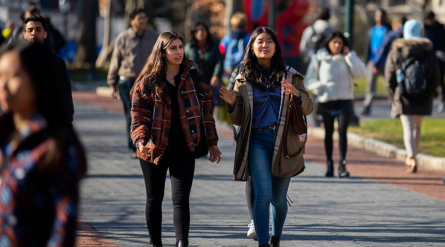 A winter scene on the University of Pennsylvania campus, with students walking near the LOVE statue.