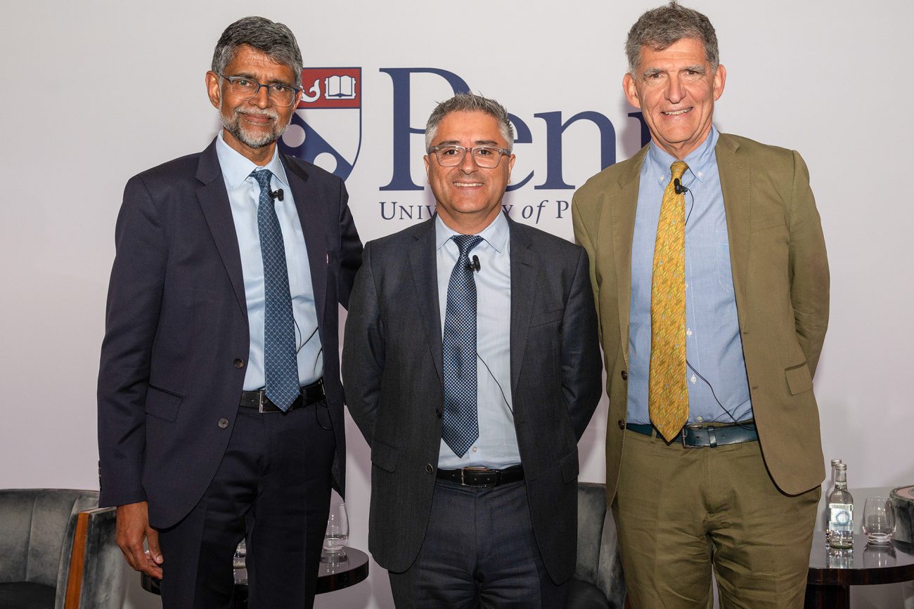 Vijay Kumar, the Nemirovsky Family Dean of Penn Engineering, stands alongside René Vidal and Dan Rader following their discussion during Penn's London academic symposium.