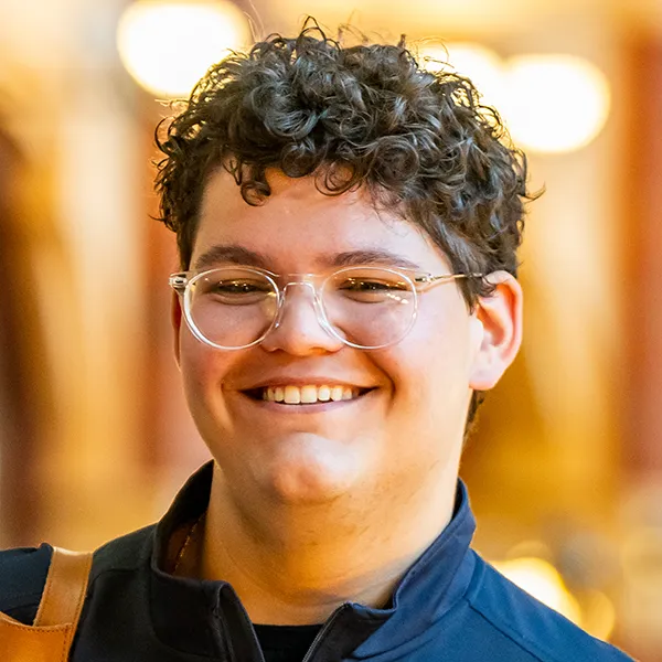 Noah Milad smiles broadly in a portrait photo