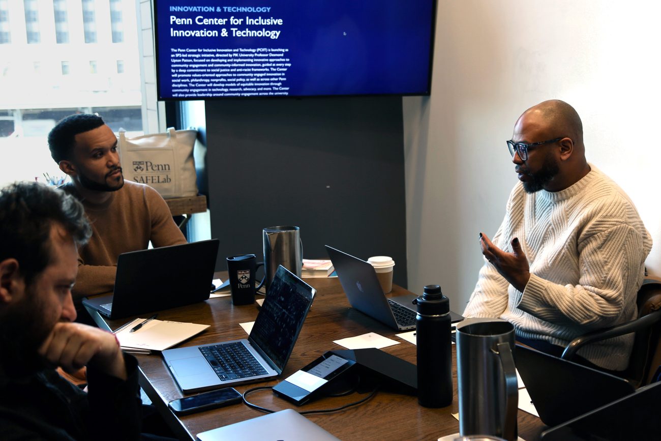 Two people carry on a discussion in a conference room