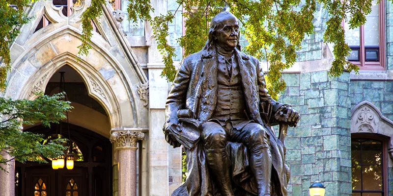 Statue of Benjamin Franklin in front of College Hall at Penn, symbolizing the University’s historic legacy and philanthropic spirit.