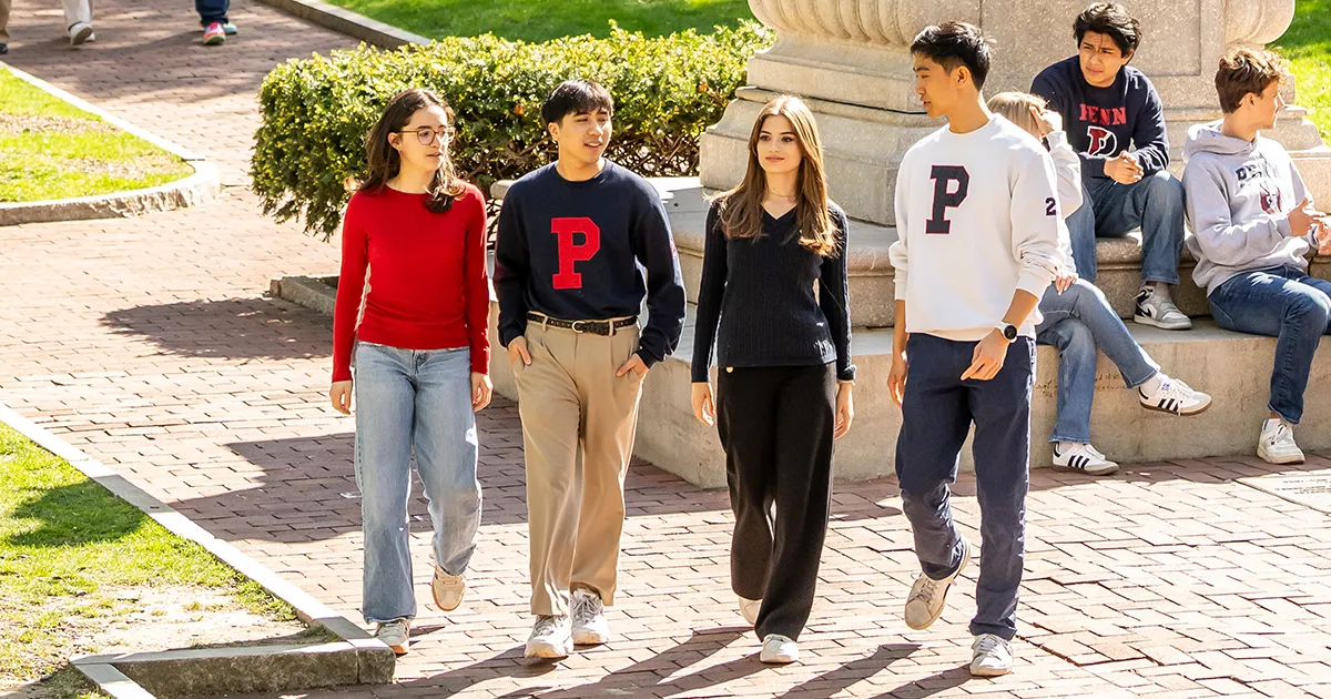 University of Pennsylvania undergraduates enjoy campus life, walking and chatting outside on Locust Walk.