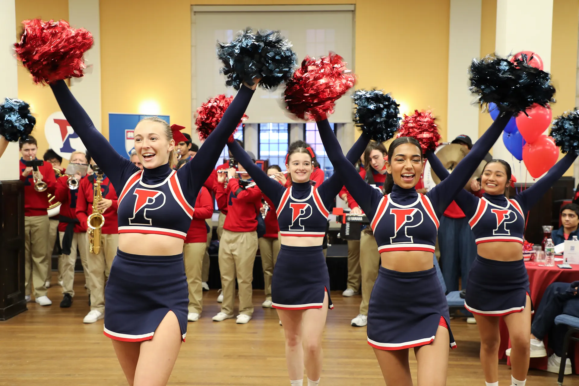 Penn cheerleaders leading a spirited performance inside Houston Hall