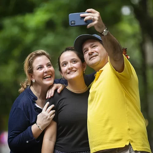 Smiling family takes a selfie on Penn’s campus, symbolizing their connection to the broader university community as proud supporters of their student.