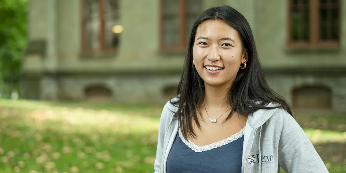 Smiling Penn student Ashley Tang outdoors near College Hall.
