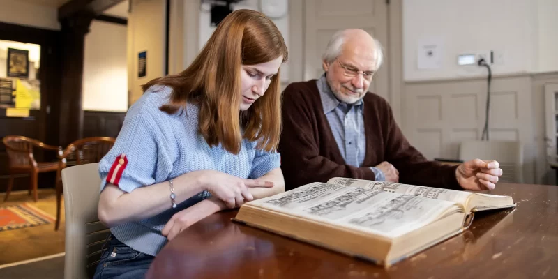 Penn student and professor explore a rare volume together, reflecting the research opportunities and faculty engagement supported by The Penn Fund.