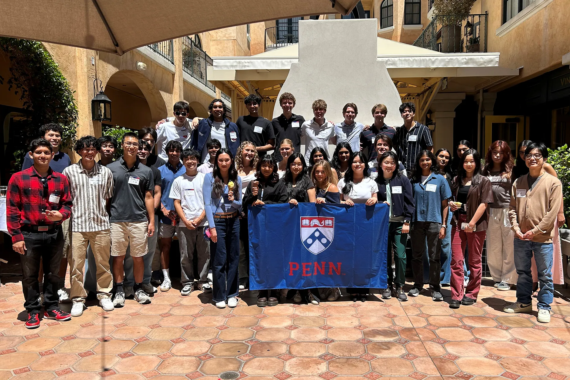 Incoming Penn students pose for a group photo together during a welcome reception in Palo Alto.
