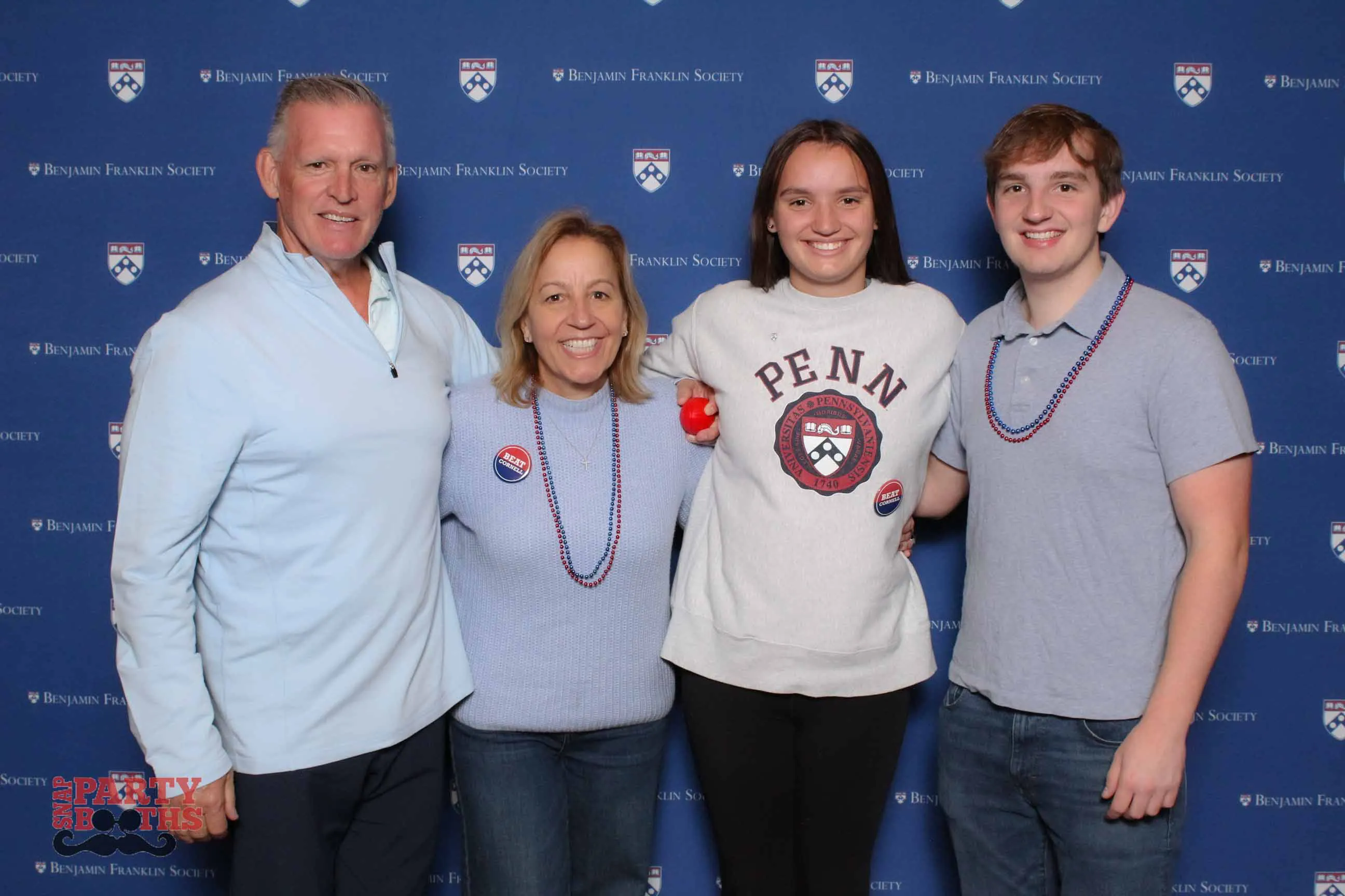 Brunch attendees pose with Penn pride at the step-and-repeat